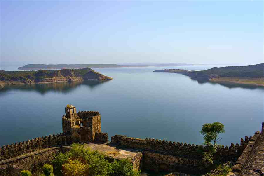 Fortress wall and tower overlooking a wide blue lake