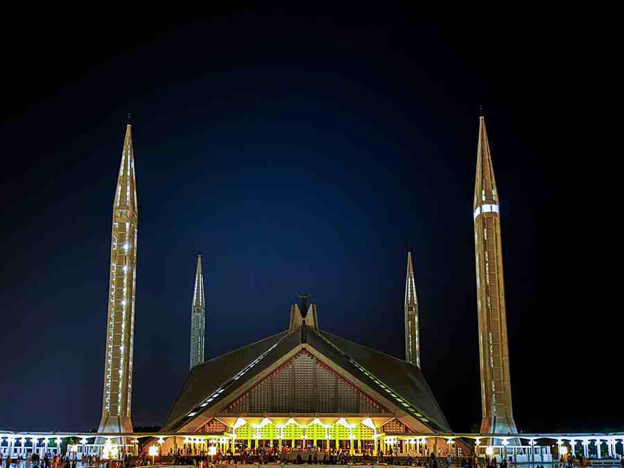 Faisal Mosque illuminated against the night sky